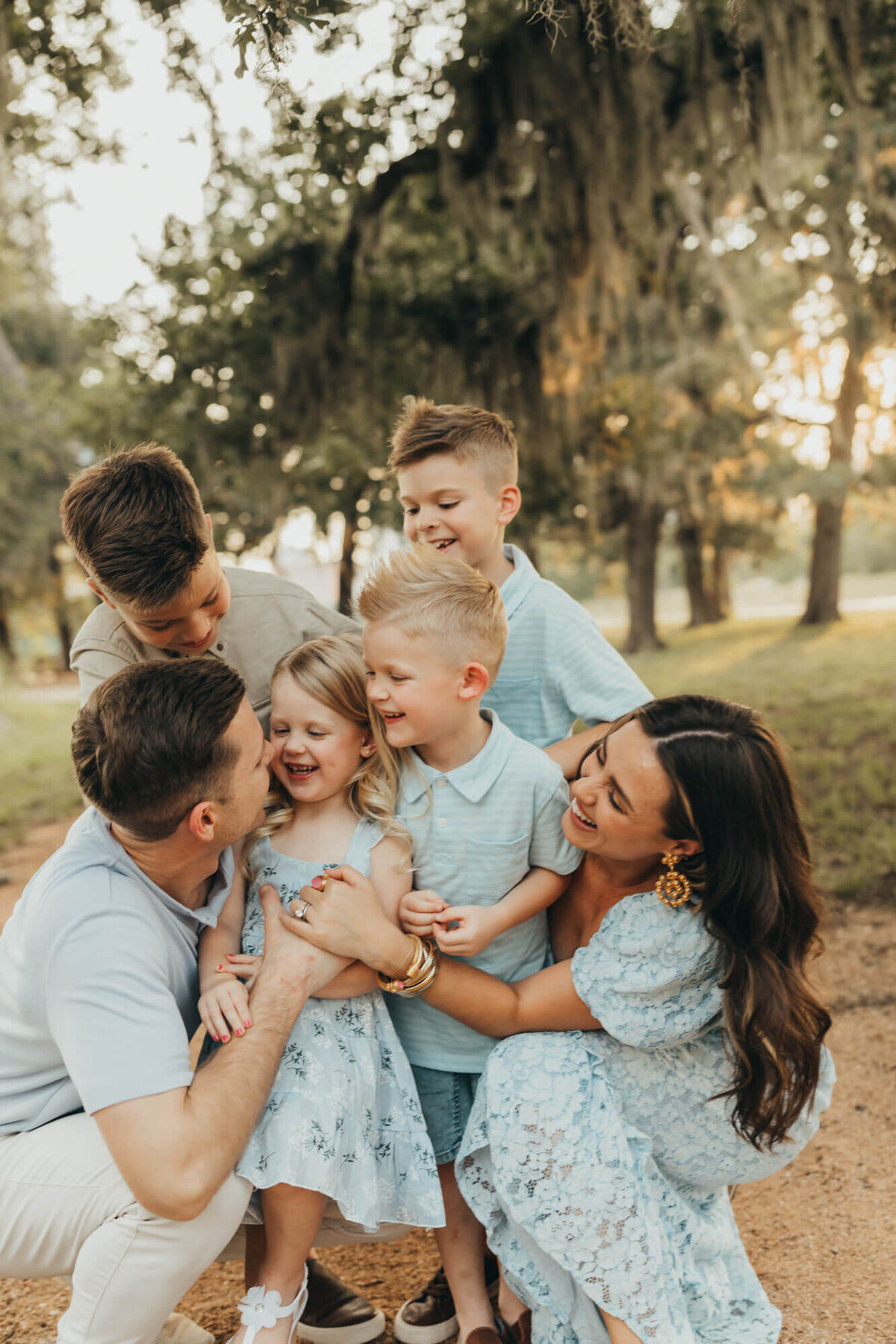 Elly Brown, influencer, holds her family tight while tickling littlest child.