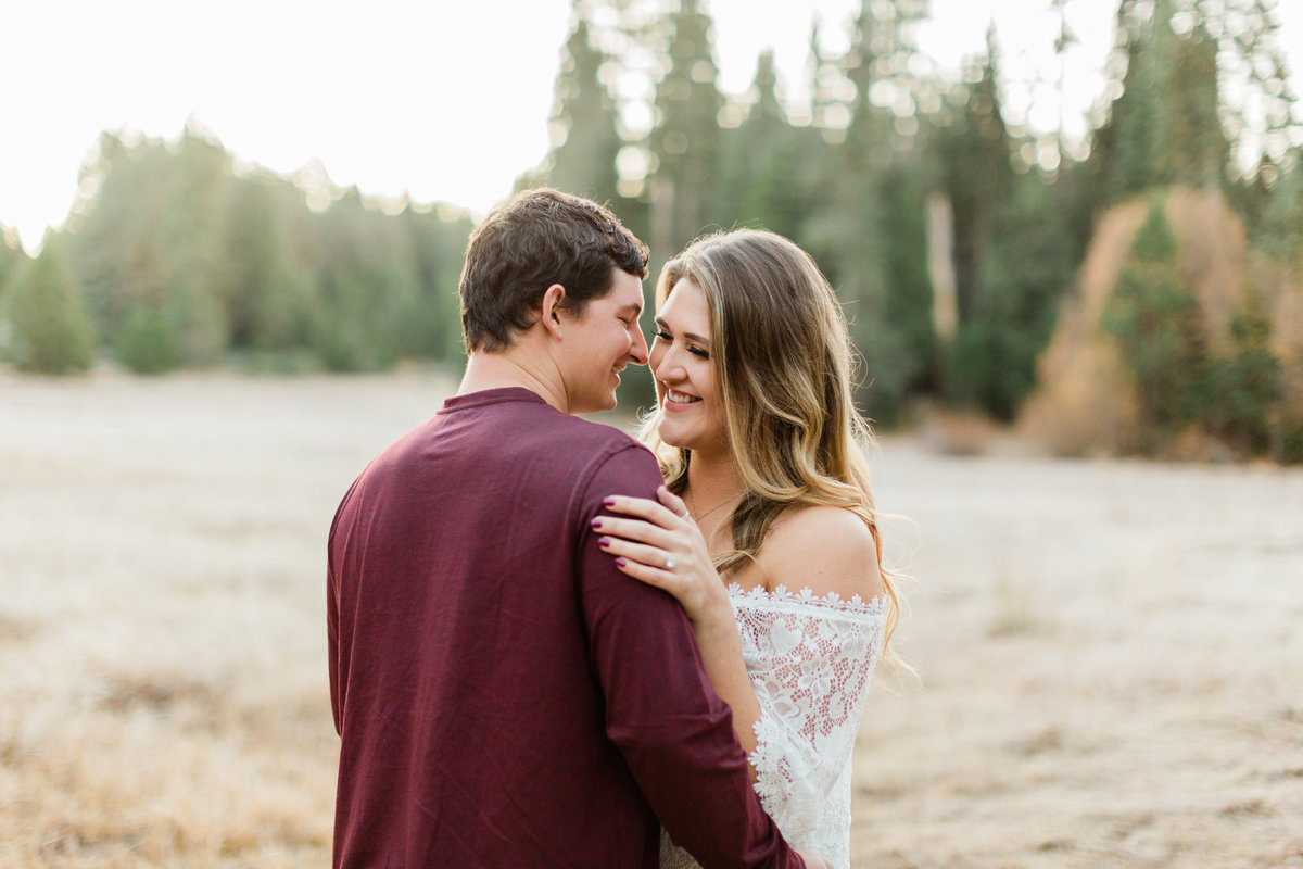 engaged couple dancing in a meadow in shaver lake california
