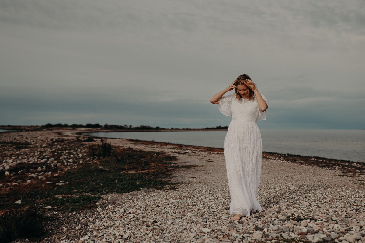 Bride walking on the beach during her elopement in norway