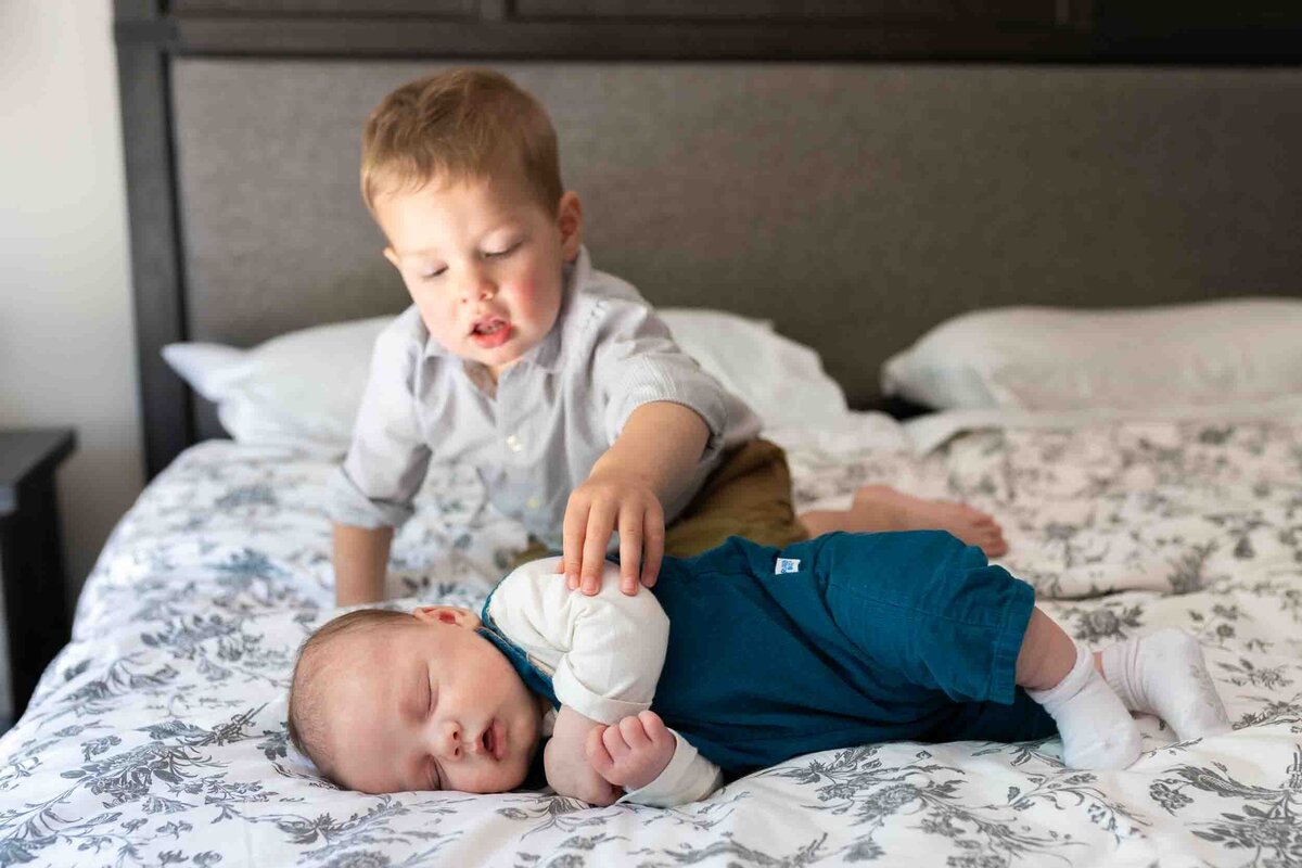 big brother pointing to baby brother