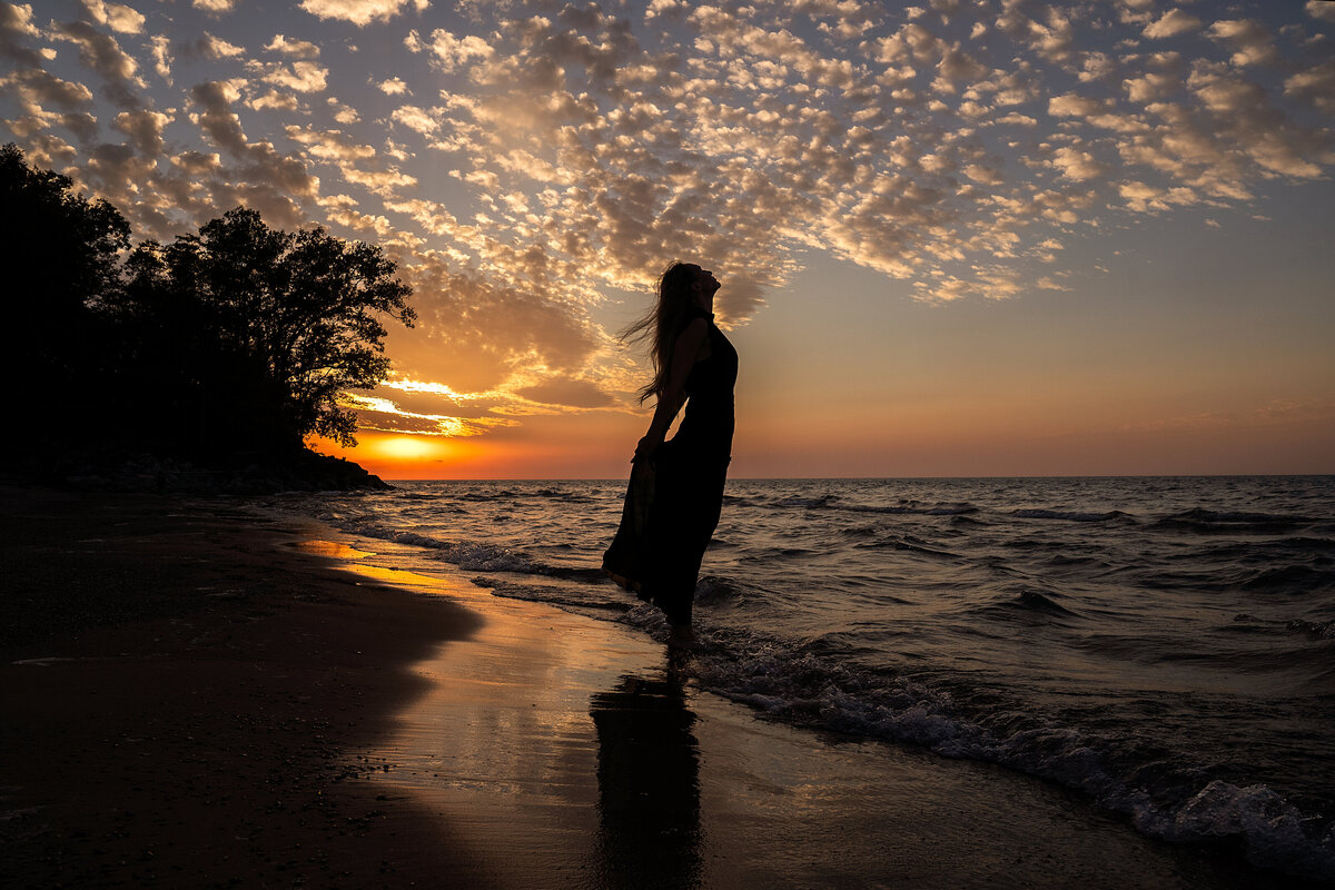one of the most beautiful sunsets i have ever seen during photoshoot in Indiana dunes National Park at Lake  Michigan beach.  Stunning Silhouette of a woman.