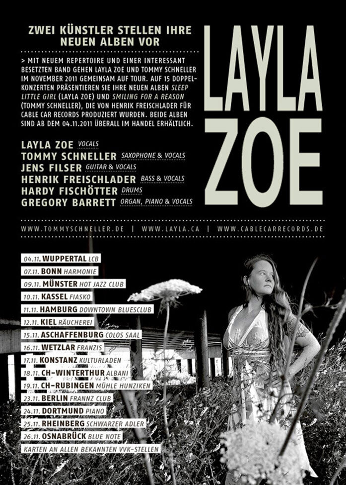 Tour Poster Artist LayLa Zoe standing in tall grass field with flowers wearing summer dress black and white