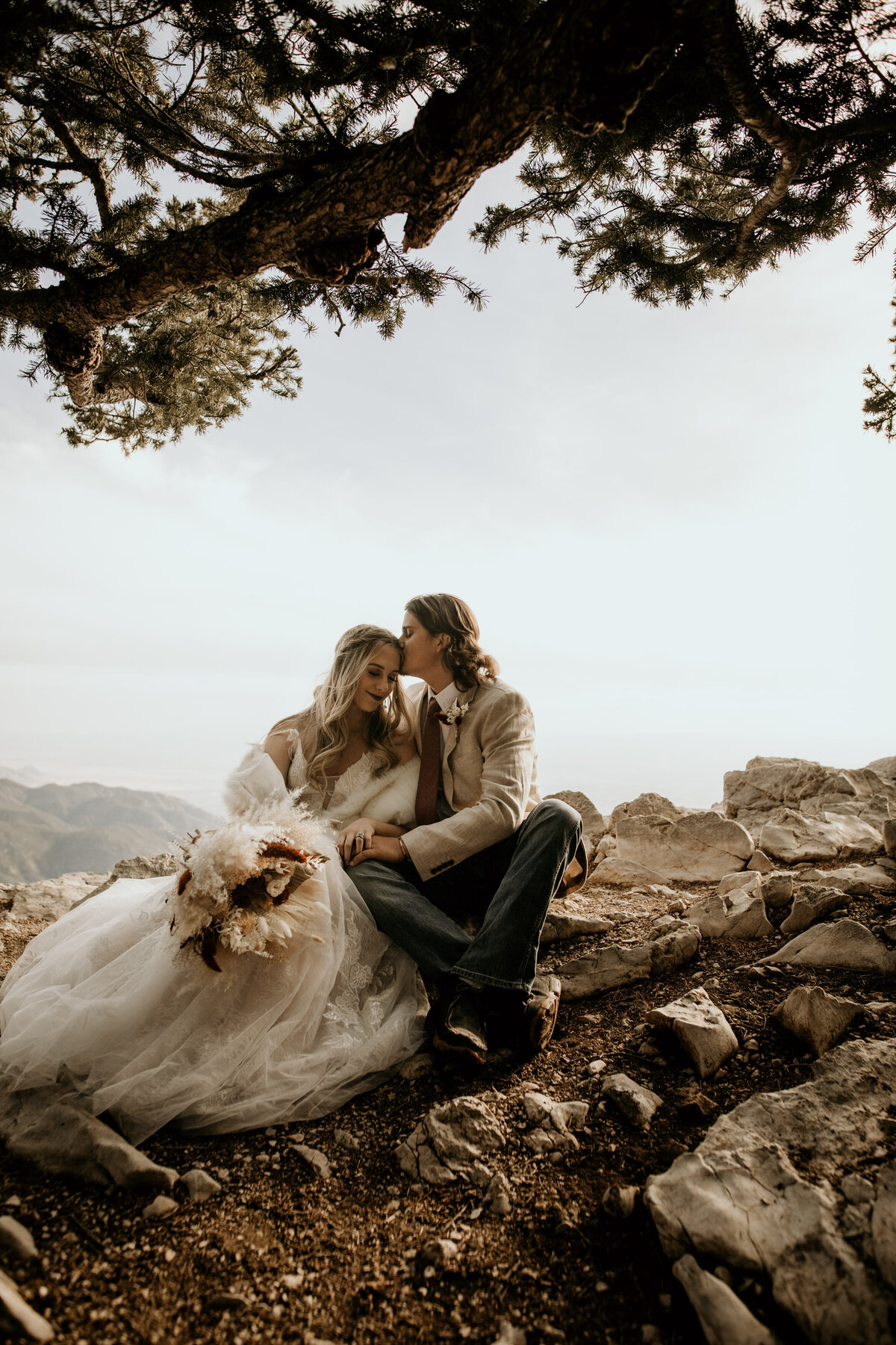 bride and groom sitting on the sandia peak in Albuquerque
