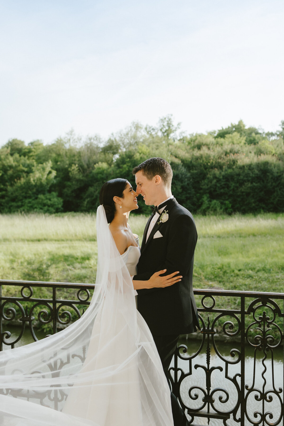 A married couple embraces at a country chateau wedding in France.