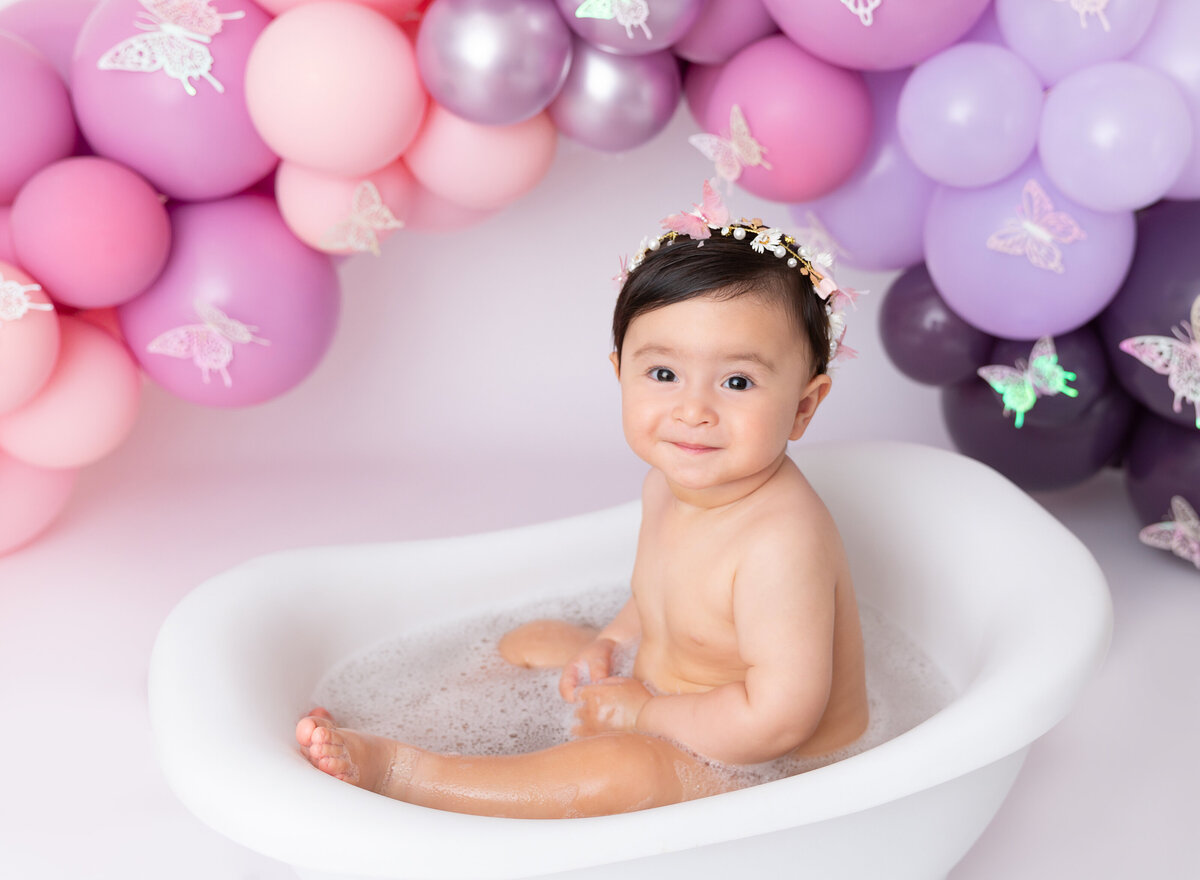 cake smash photosession with bubble bath for  girl  pink purple balloons setup Brooklyn NYC