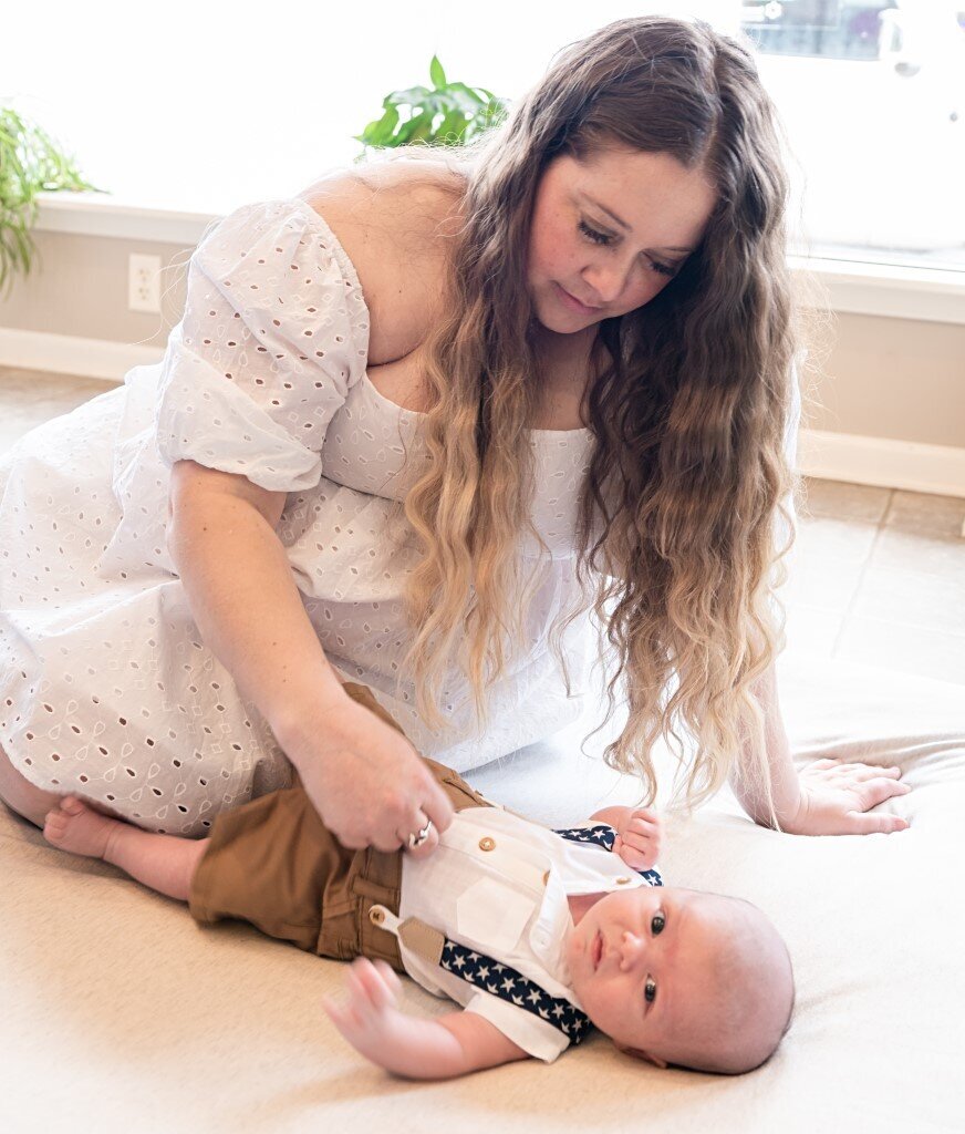 mom playing with newborn boy