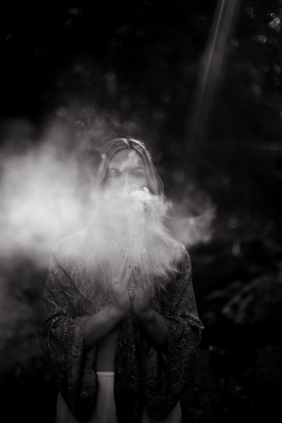 Black and white image of girl with smoke