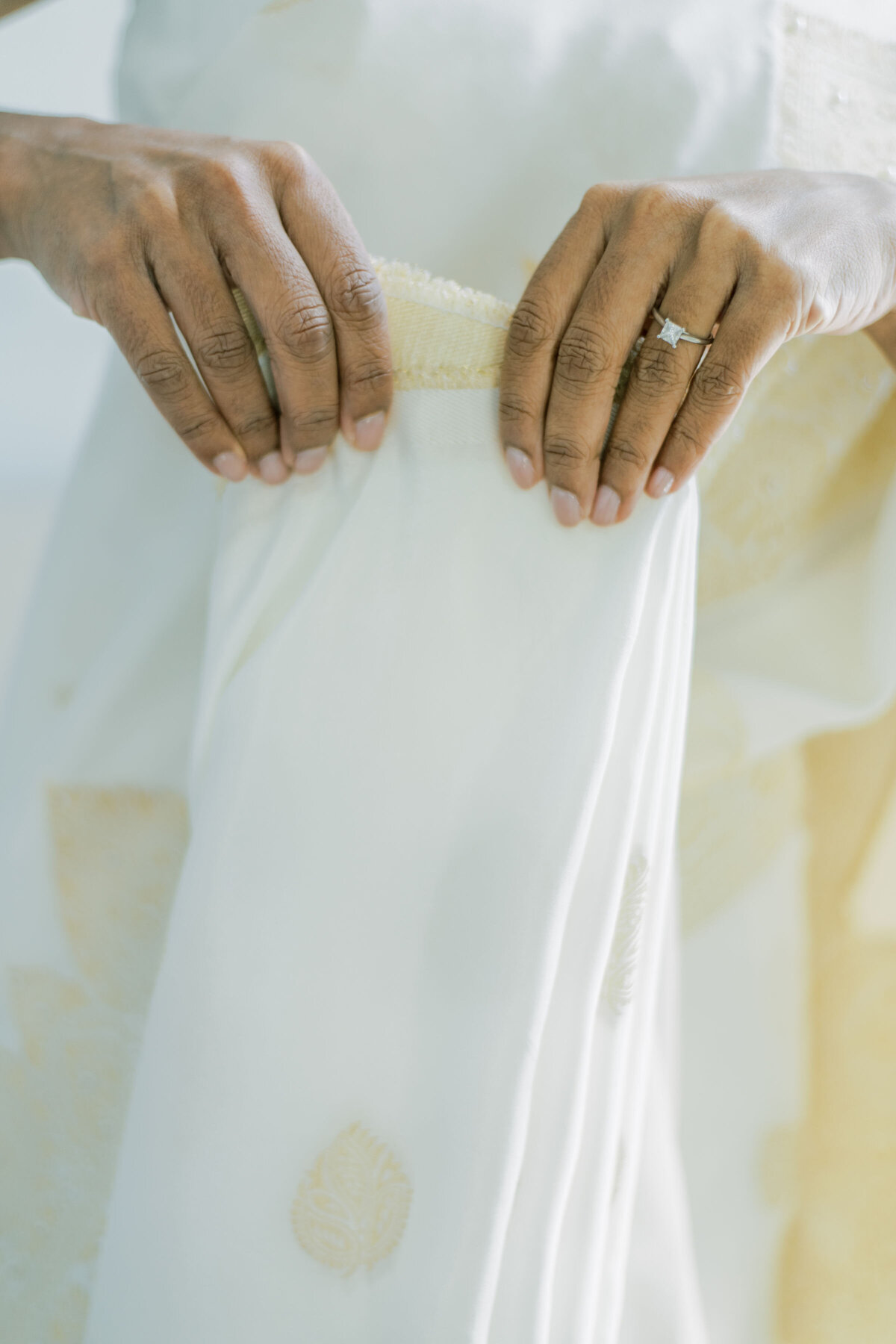 Bride is folding her dress .