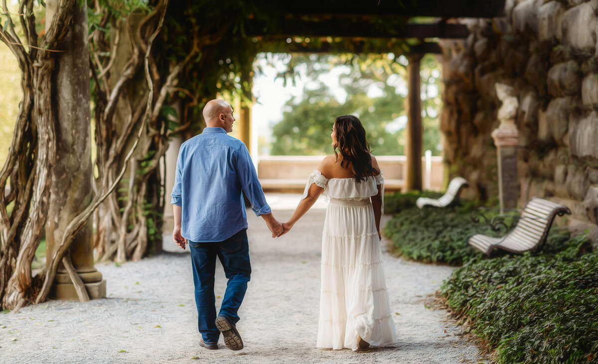 Couple walks together during Family Photoshoot at Biltmore Estate in Asheville, NC.