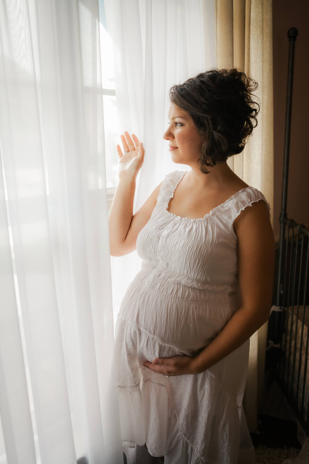 Beautiful pregnant woman in white dress.