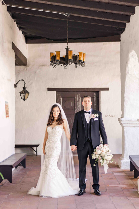 bride-and-groom-in-hallway-at-mission-san-diego-de-alcala