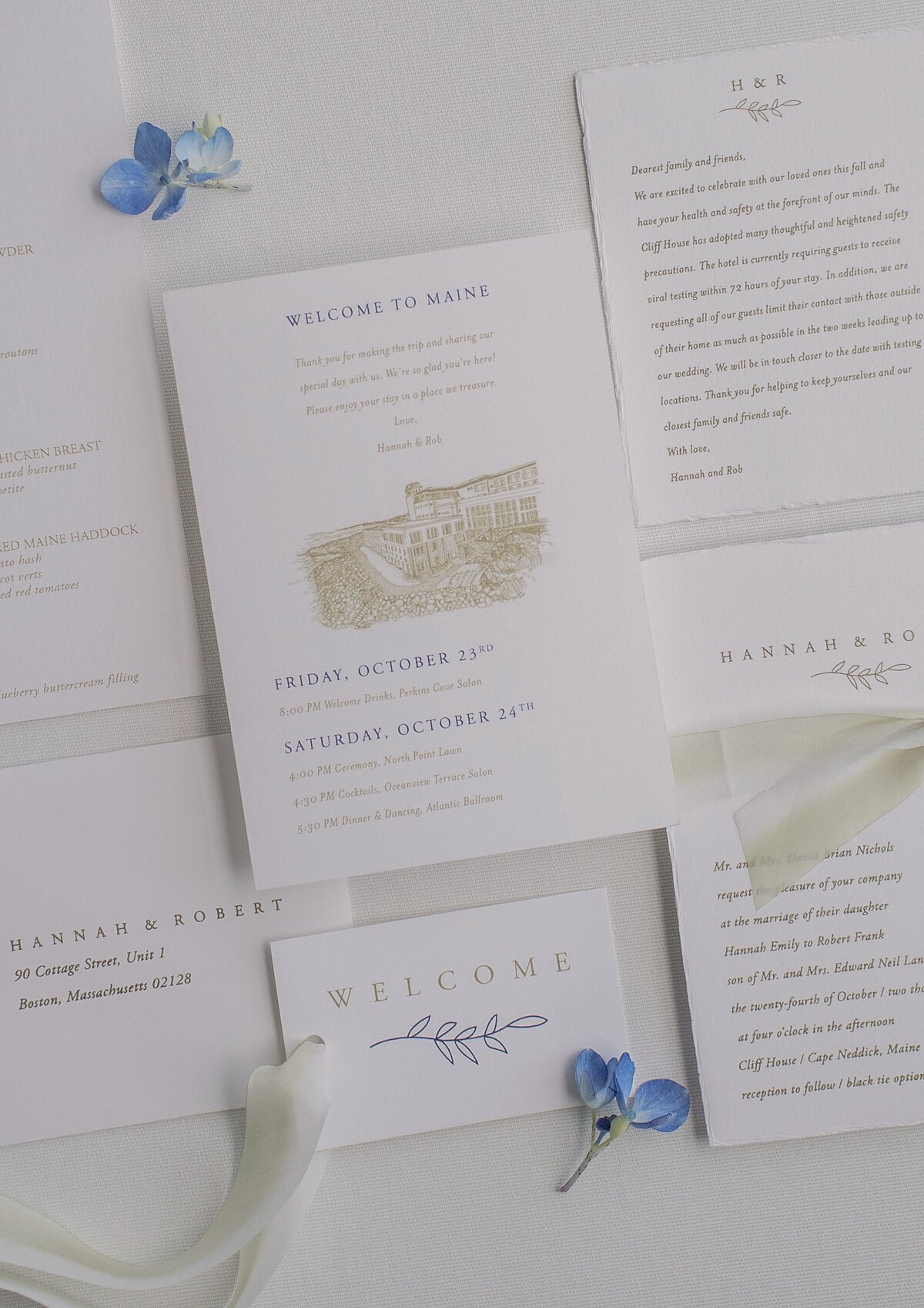 Flat lay of cream and gold wedding stationary.