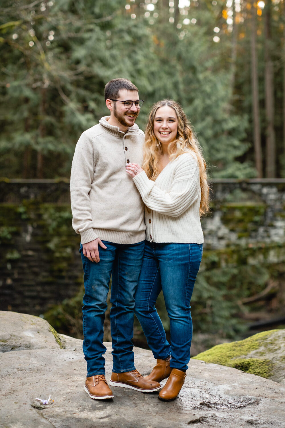 Couple poses in a PNW forest for engagement photos