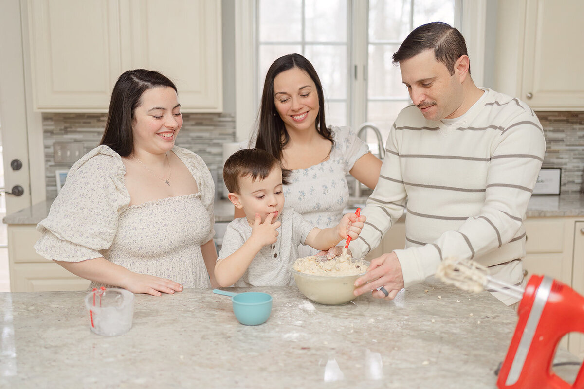 parents and kids baking a cake together during Woodbridge, VA family photography