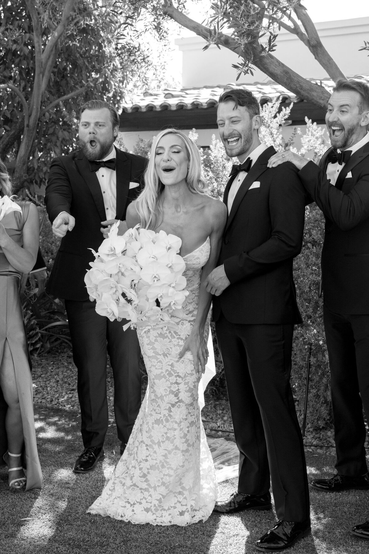 Candid moment of bride and groom with bridal party