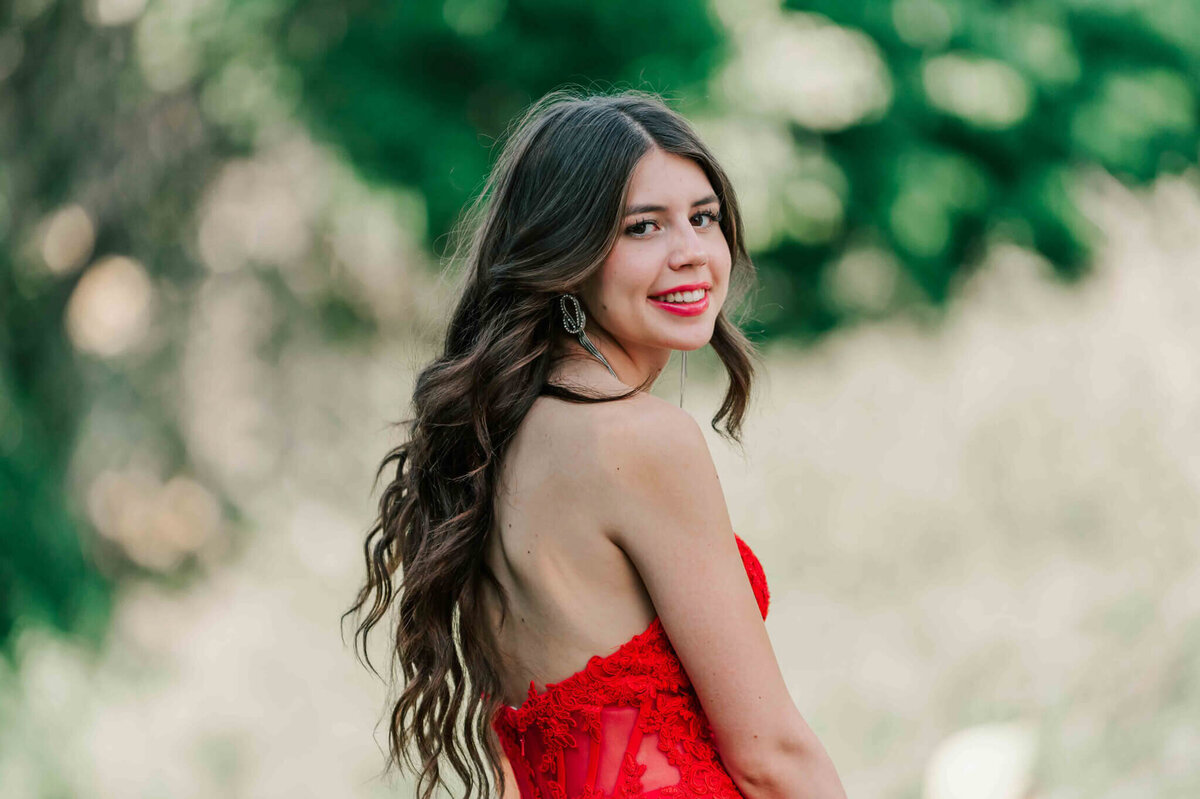 Looking of her shoulder towards the camera. 