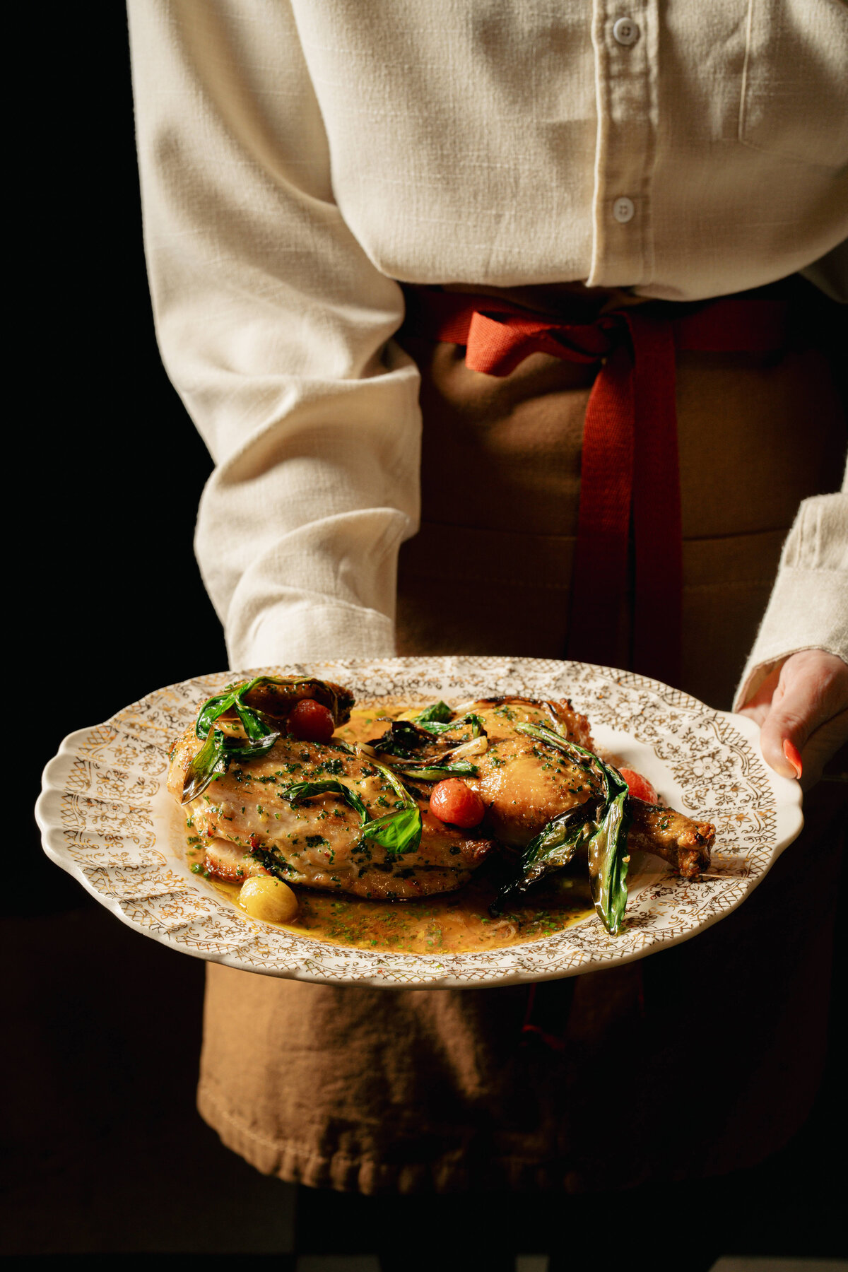 Commercial Food Photography in Greenville, South Carolina featuring a server holding a plate of duck