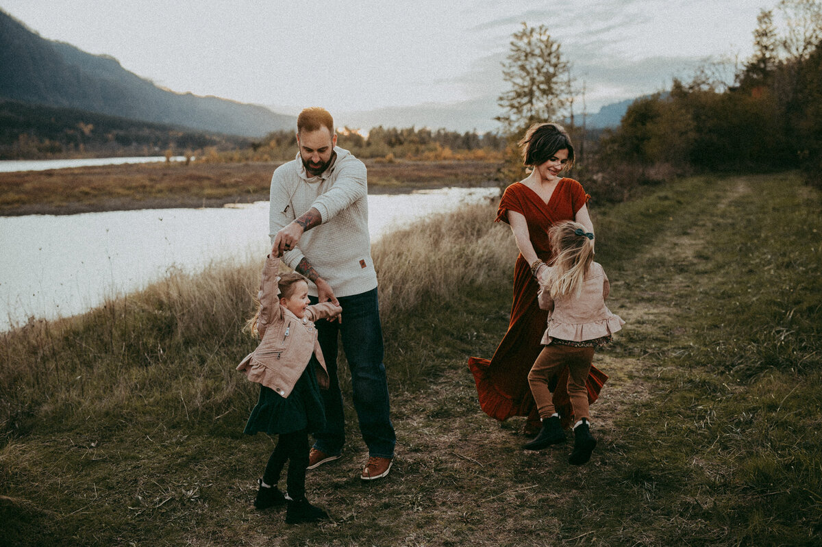 mom, dad and baby at the park with their dogs during session with Portland photographer