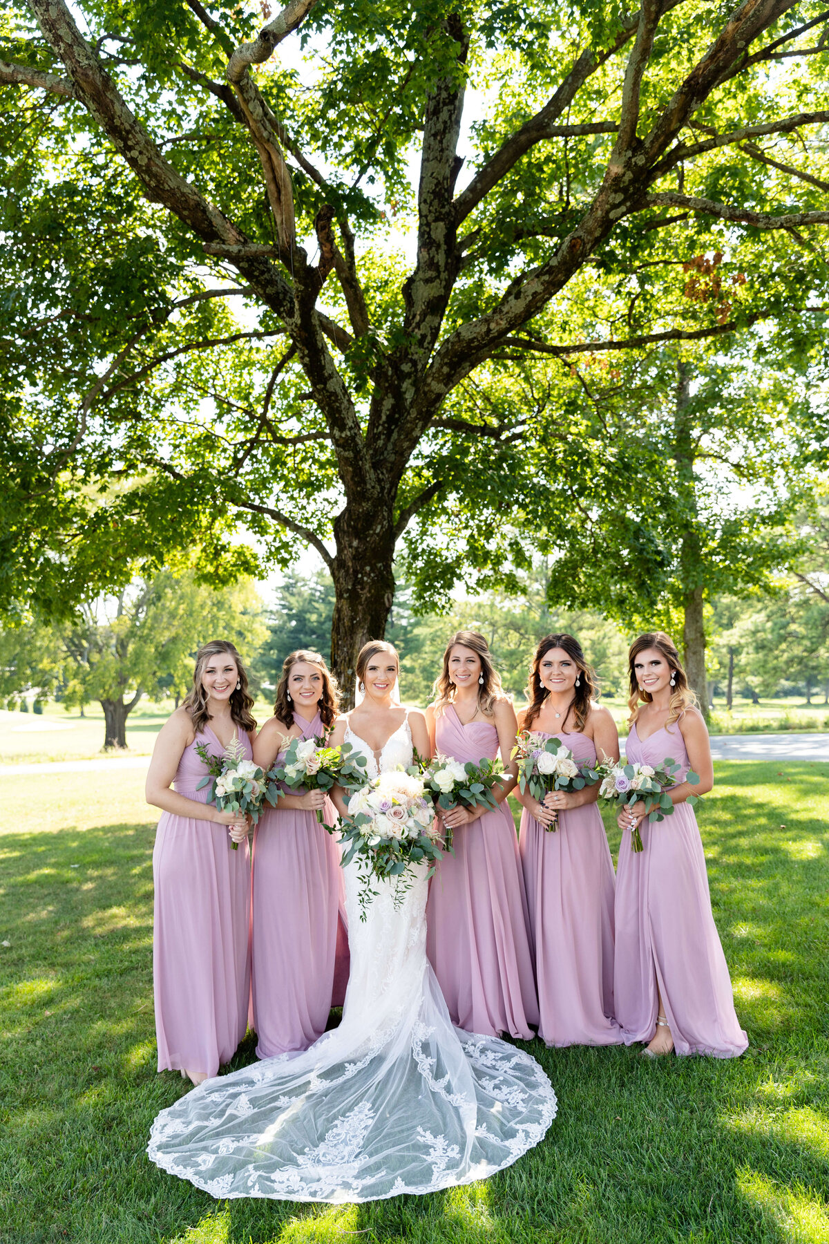 Bride with bridesmaids in purple dresses