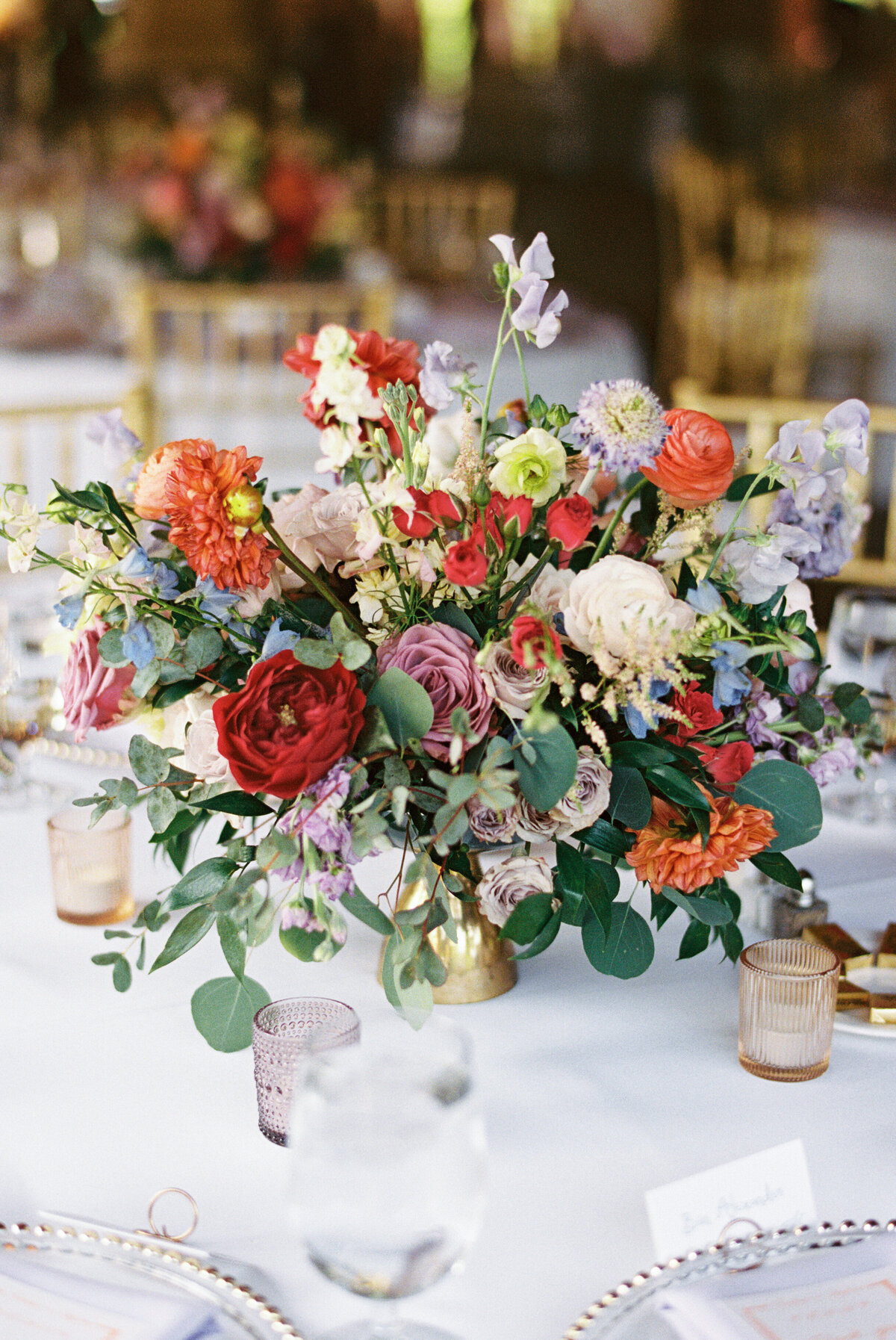 Colorful garden-inspired floral centerpiece in shades of coral, lavender, and blush at Gervasi Vineyard wedding reception