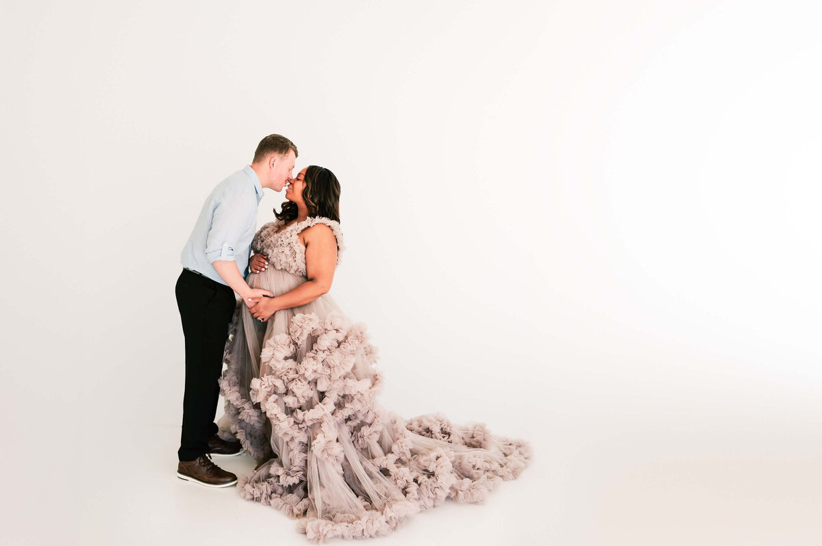 pregnant couple kissing captured by Springfield MO maternity photographer Jessica Kennedy of The XO Photography