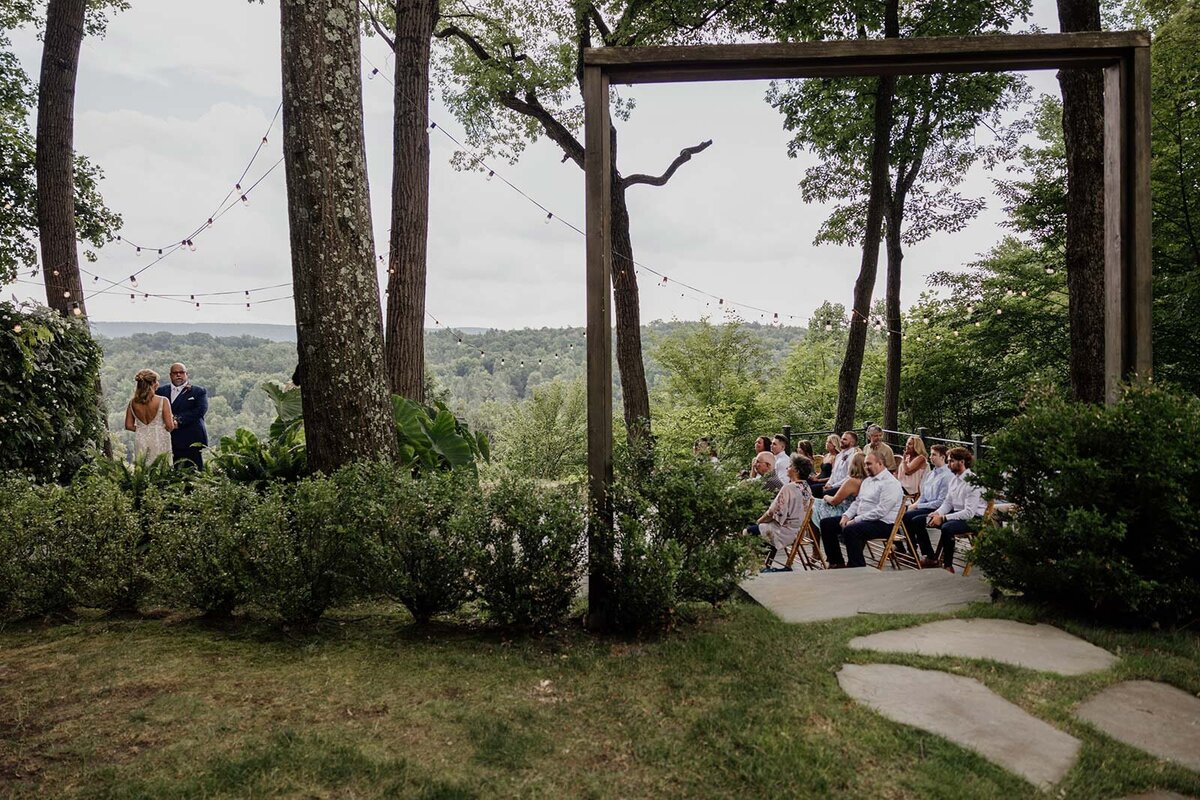 In the distance you can see the bride and groom and their immediate families during their intimate elopement ceremony.
