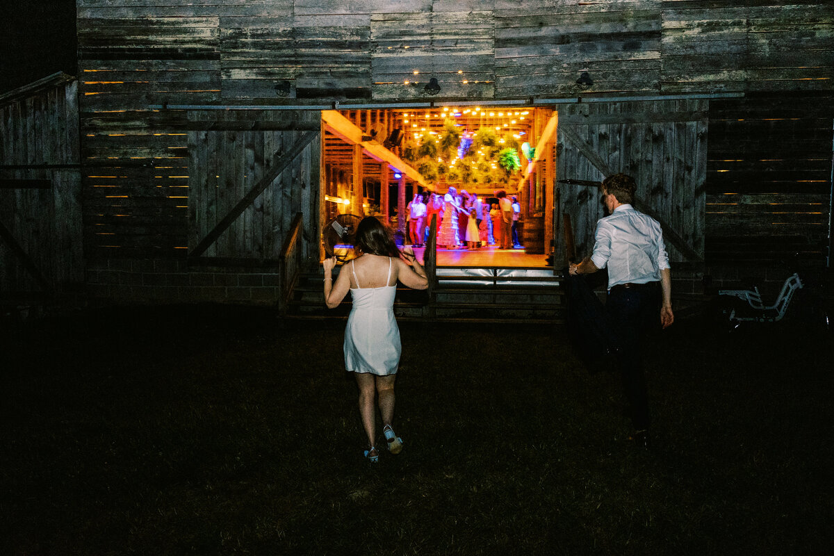 a nighttime portrait of bride and groom returning to their reception by wedding photographer Megan Lynn of My Sun and Stars Co.