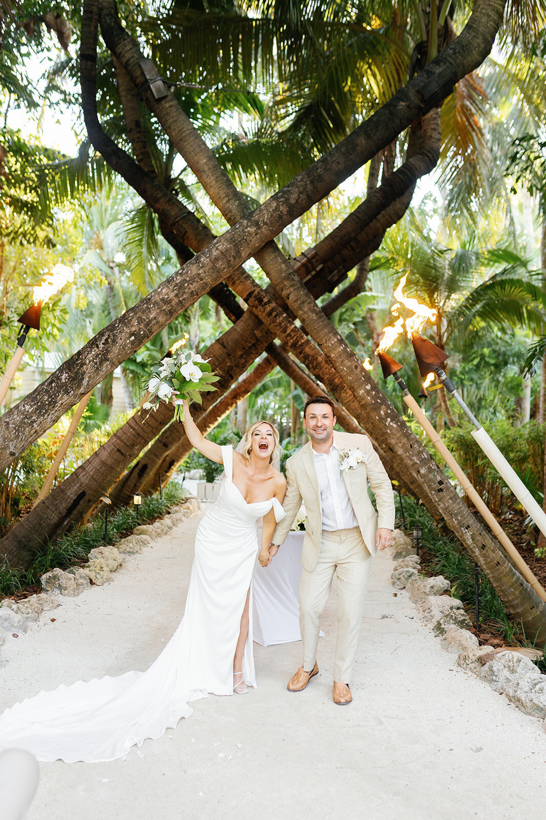 Newlyweds Monica and Austyn joyfully exit their wedding ceremony, officially married in the stunning Florida Keys.