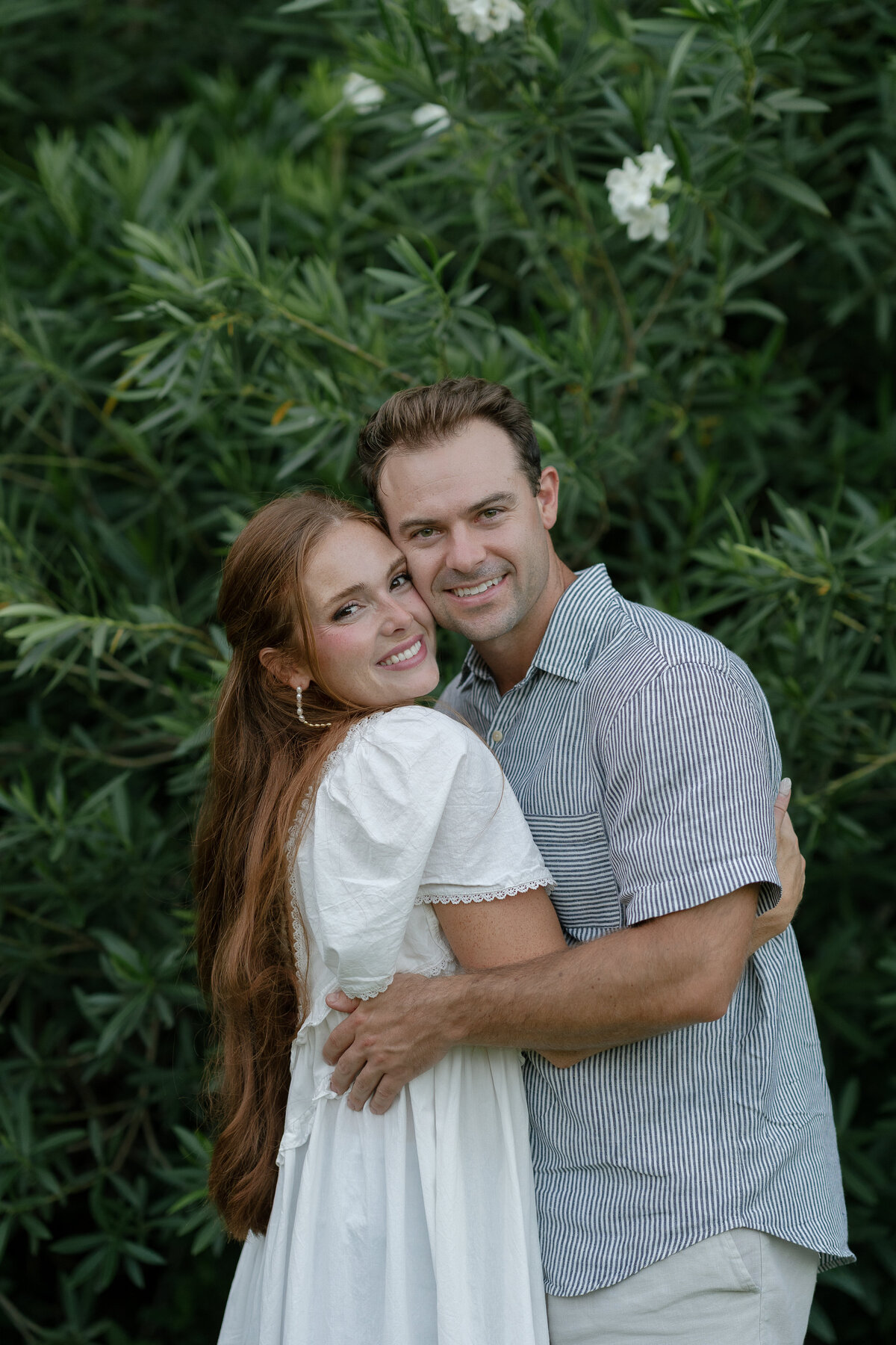 Couple hugging and smiling for florida engagement photographer, Shelby Ann Photos