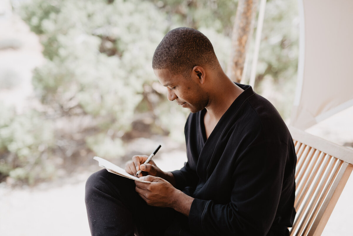 Utah Elopement Photographer captures man writing in book