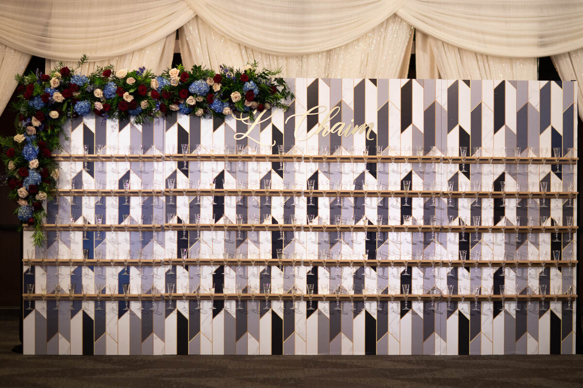 Art deco champagne wall with escort card calligraphy