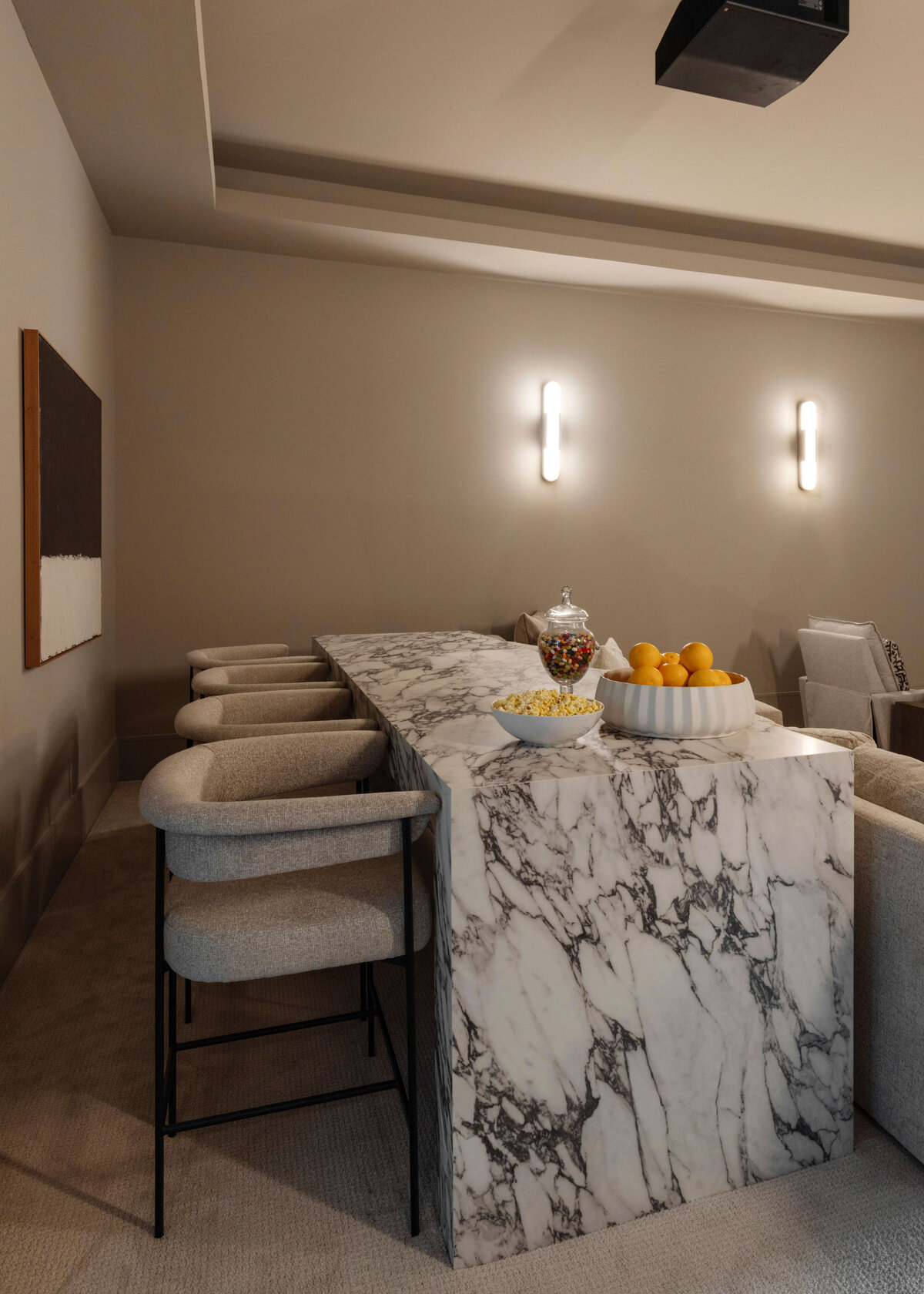 oyster creek studios hughes marble table and light tan chairs in home theare