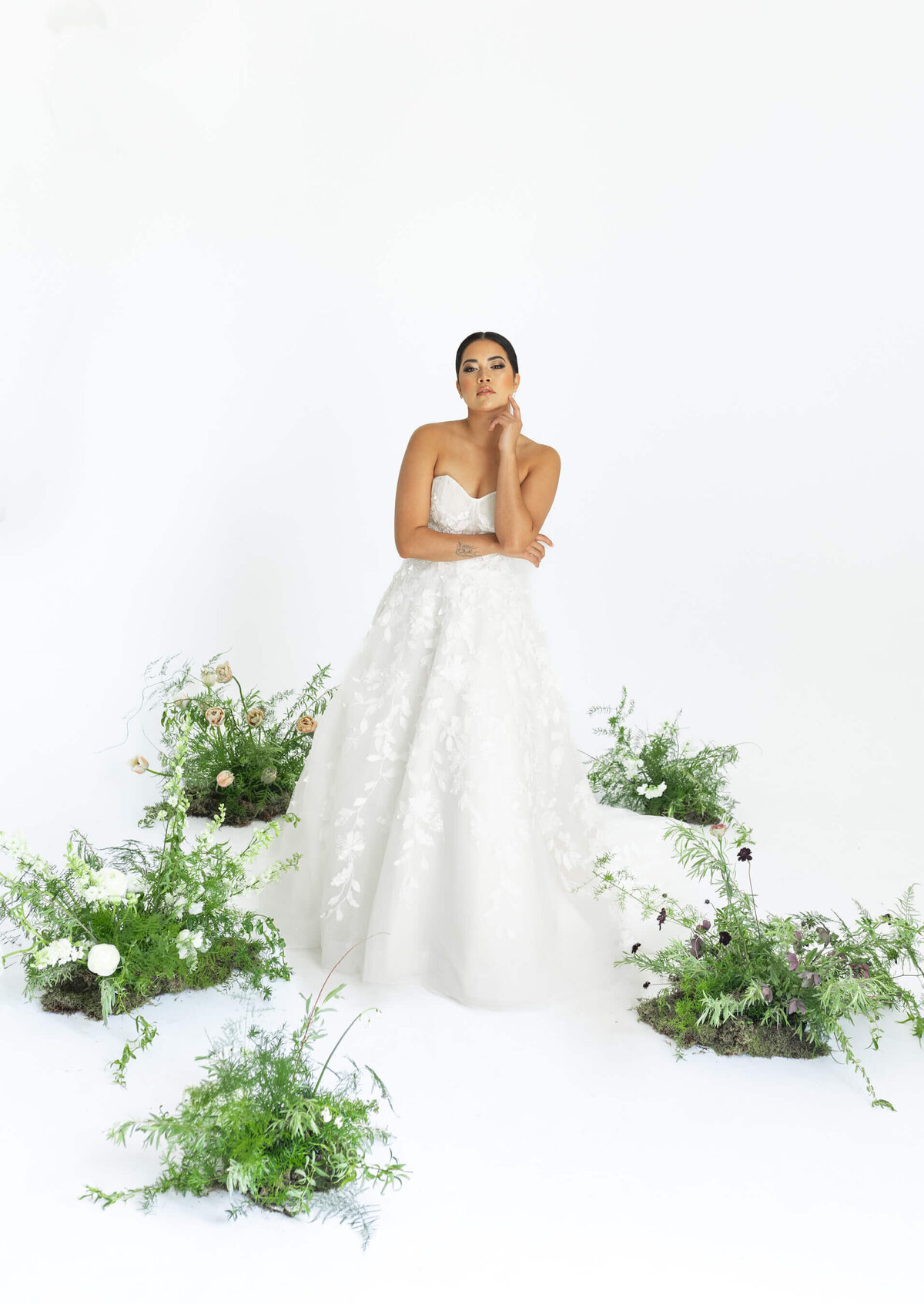 bride standing in circle of ground florals