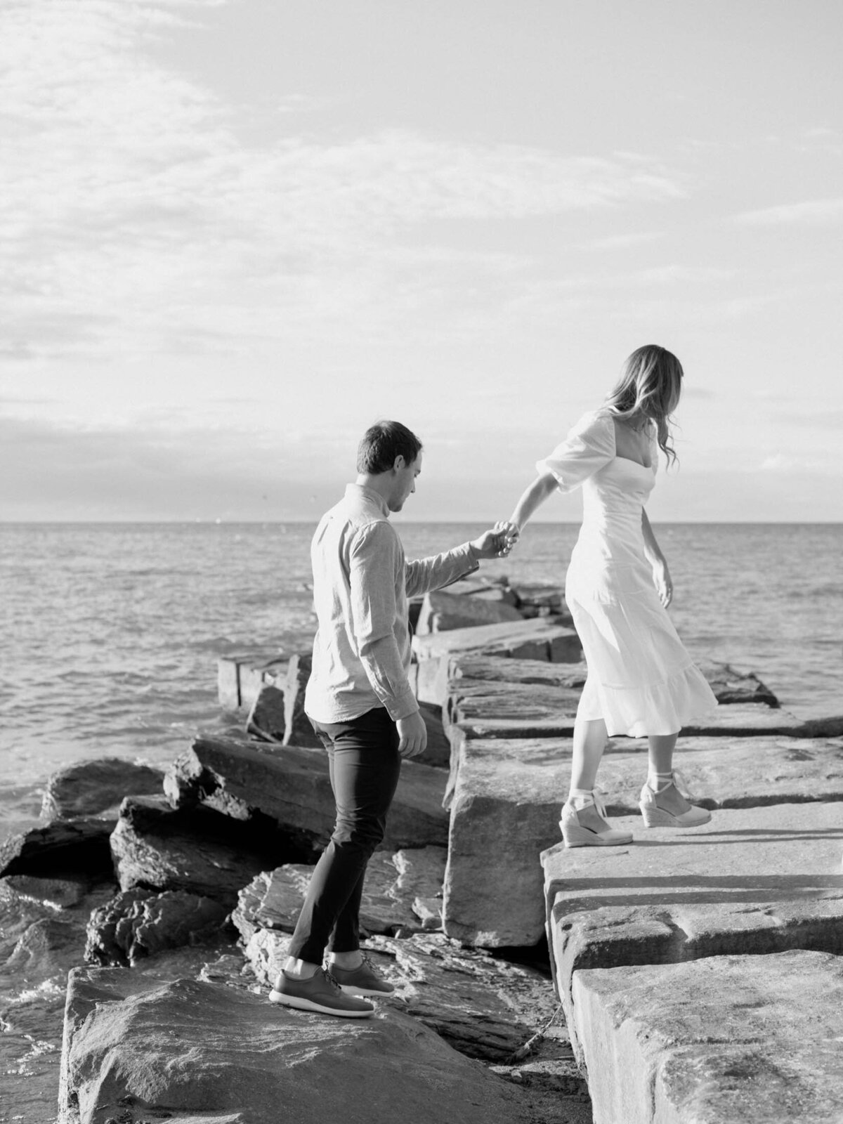 Outdoor engagement session with scenic lake views on a Cleveland beach.