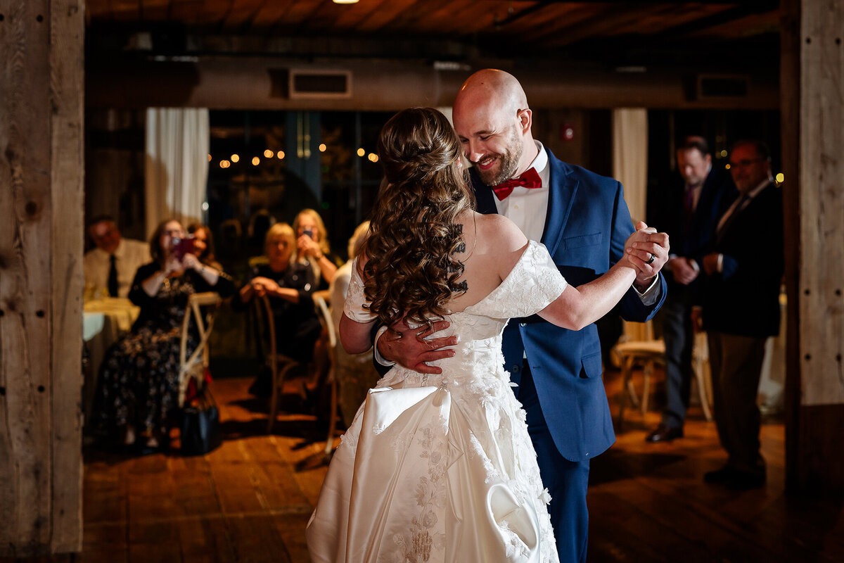 Bride and groom dancing together during their first dance at wedding reception.