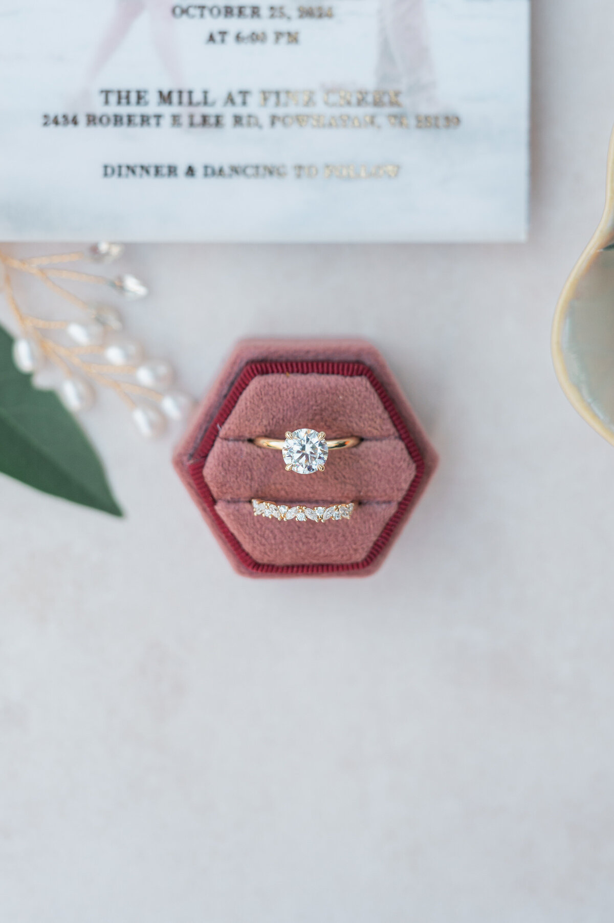 An engagement and wedding band in a red ring box
