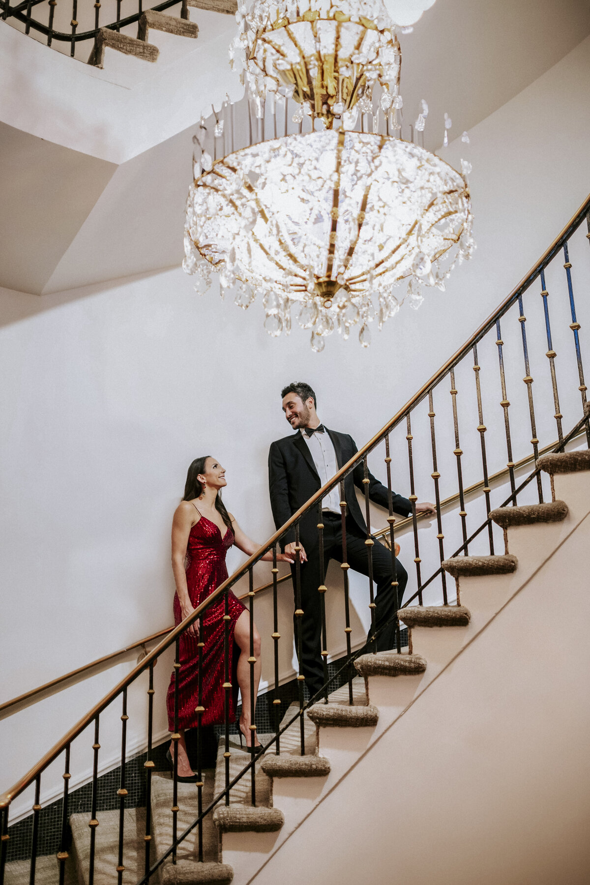 glamorous-couple-ascending-spiral-staircase