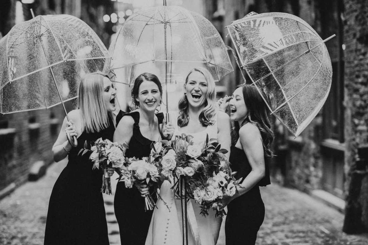 bride and bride's maids with clear umbrellas