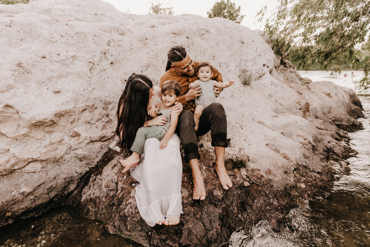 family of 4 playing during river mini session in phoenix