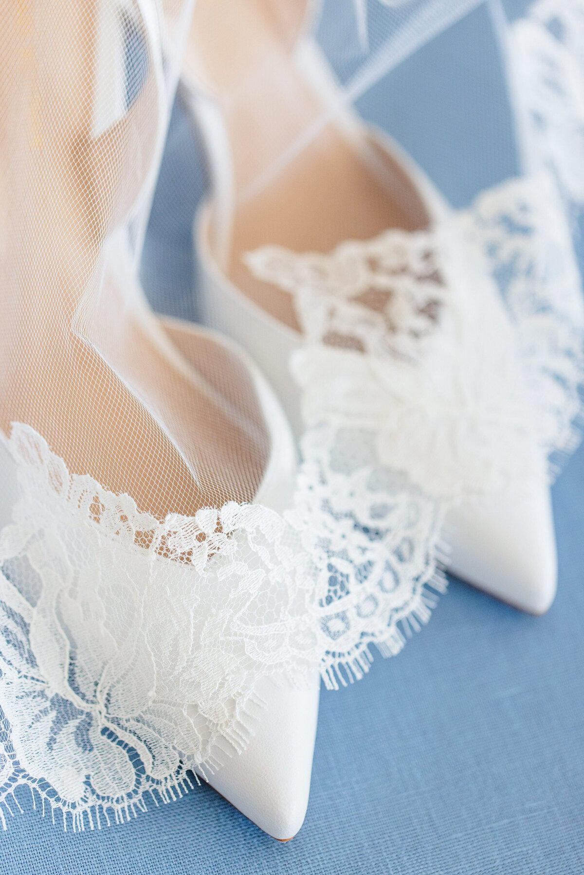 white shoes on blue background with veil lace detail