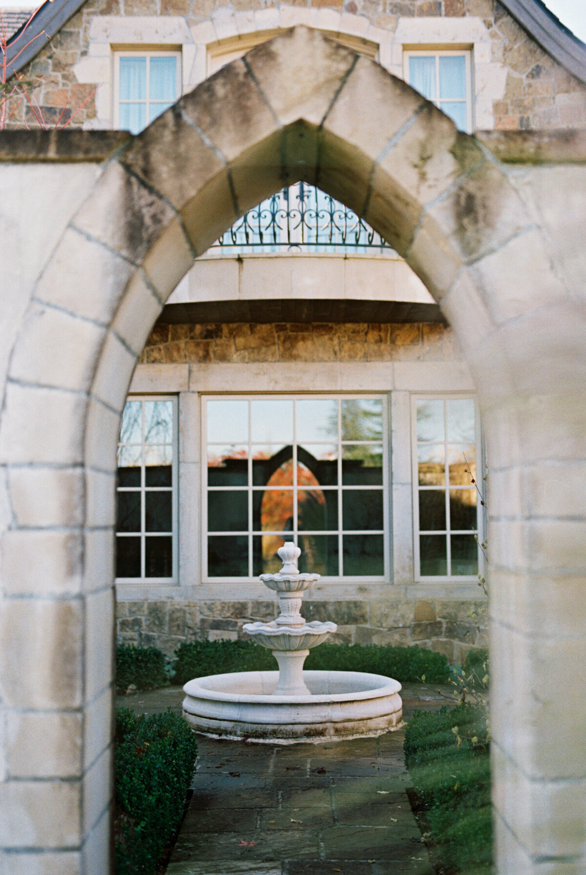 arch and fountain at chateau de lis wedding