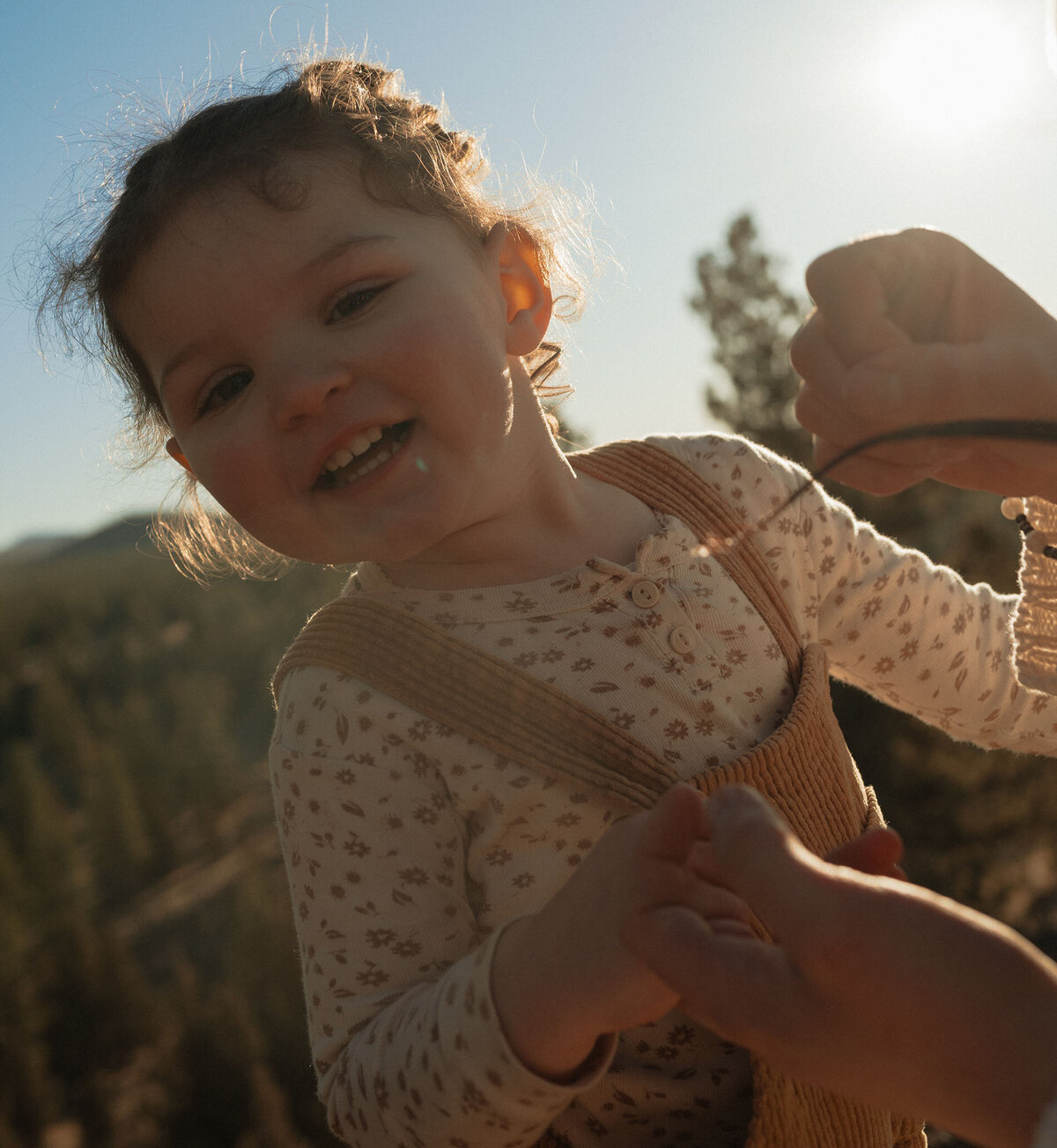 little girl laughing and expressing joy during sunset photoshoot in Bend, Oregon