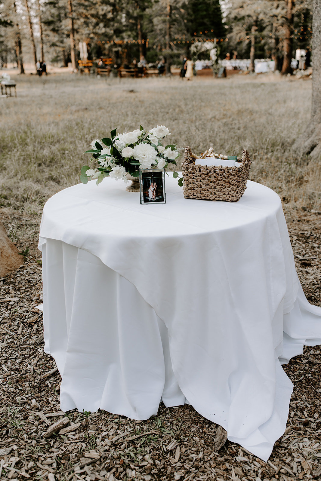 Truckee Wedding Planners couples round welcome table with white linen and simple floral at venue Mitchell's Mountain Meadows Sierraville, Joy of Life Events image by The Shepards Photography
