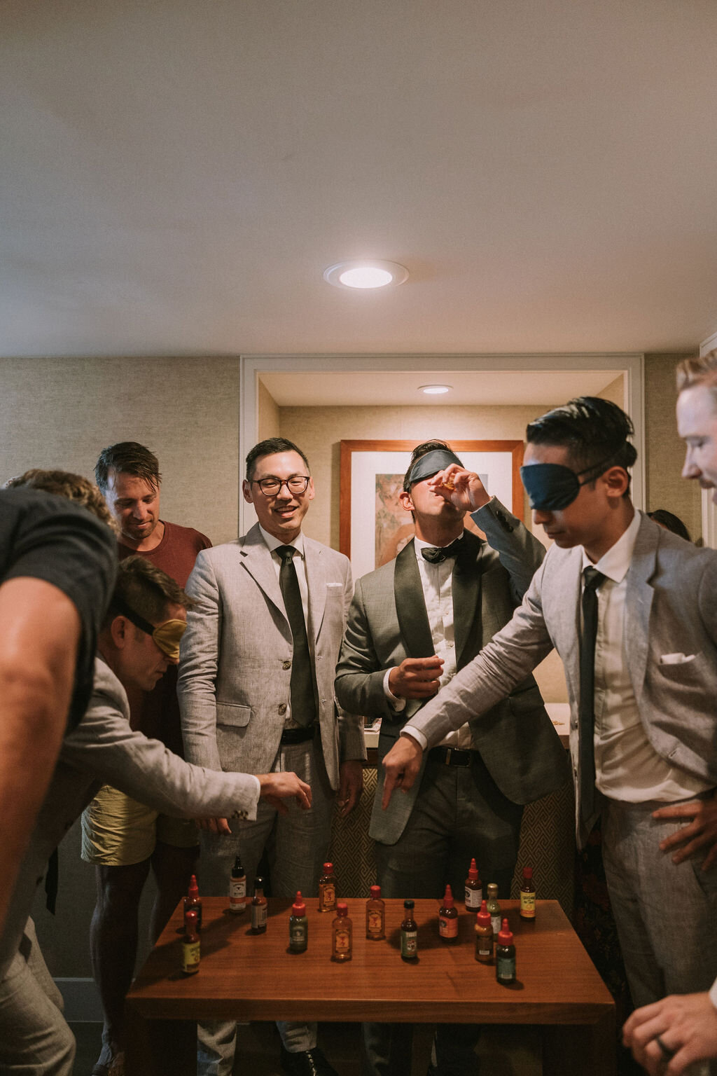 Chinese wedding game groom and groomsman playing a drinking game before wedding