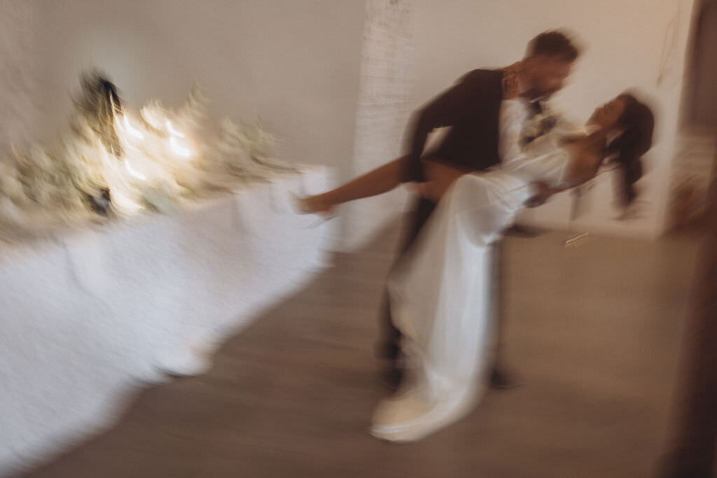 A person dipping their partner during their wedding