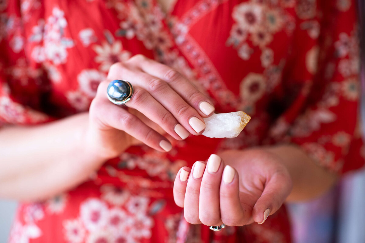Ottawa brand photos showing a closeup of a yellow crystal in a yoga instructor's hands