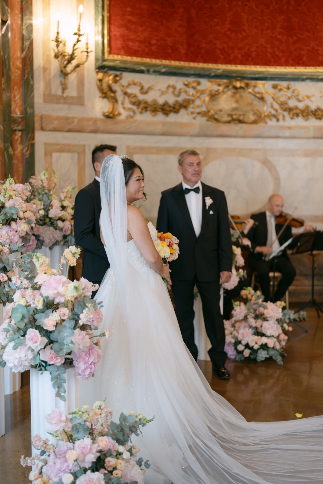 Wedding couple facing their guests at the ceremony in luxury wedding palace Daun Kinsky in Vienna