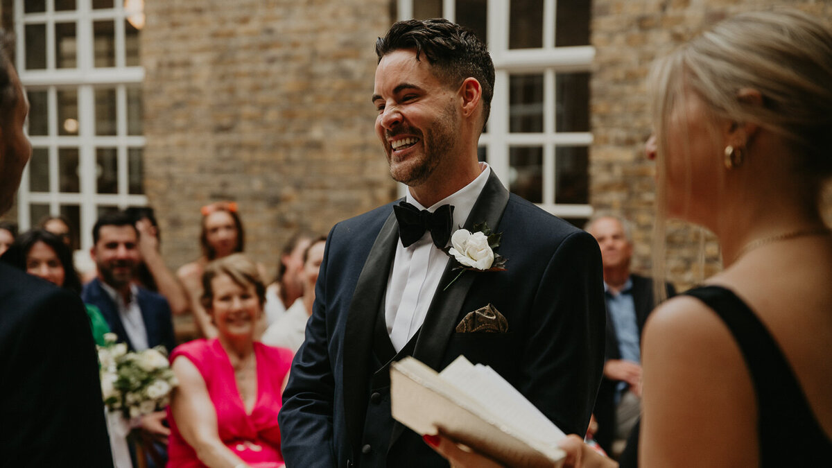 Groom smiles during the ceremony at Hackney Town Hall. 