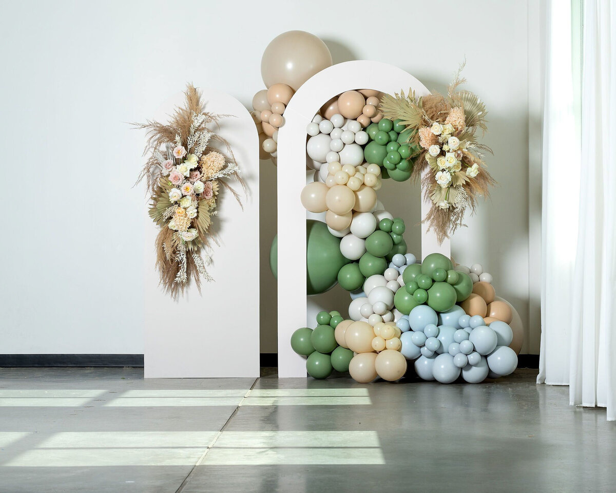 Arched wedding backdrop, with boho floral installation and balloons featuring rentals from Stef Forward Events, trendy and modern decor rentals based in Calgary, AB. Featured on the Brontë Bride Vendor Guide.