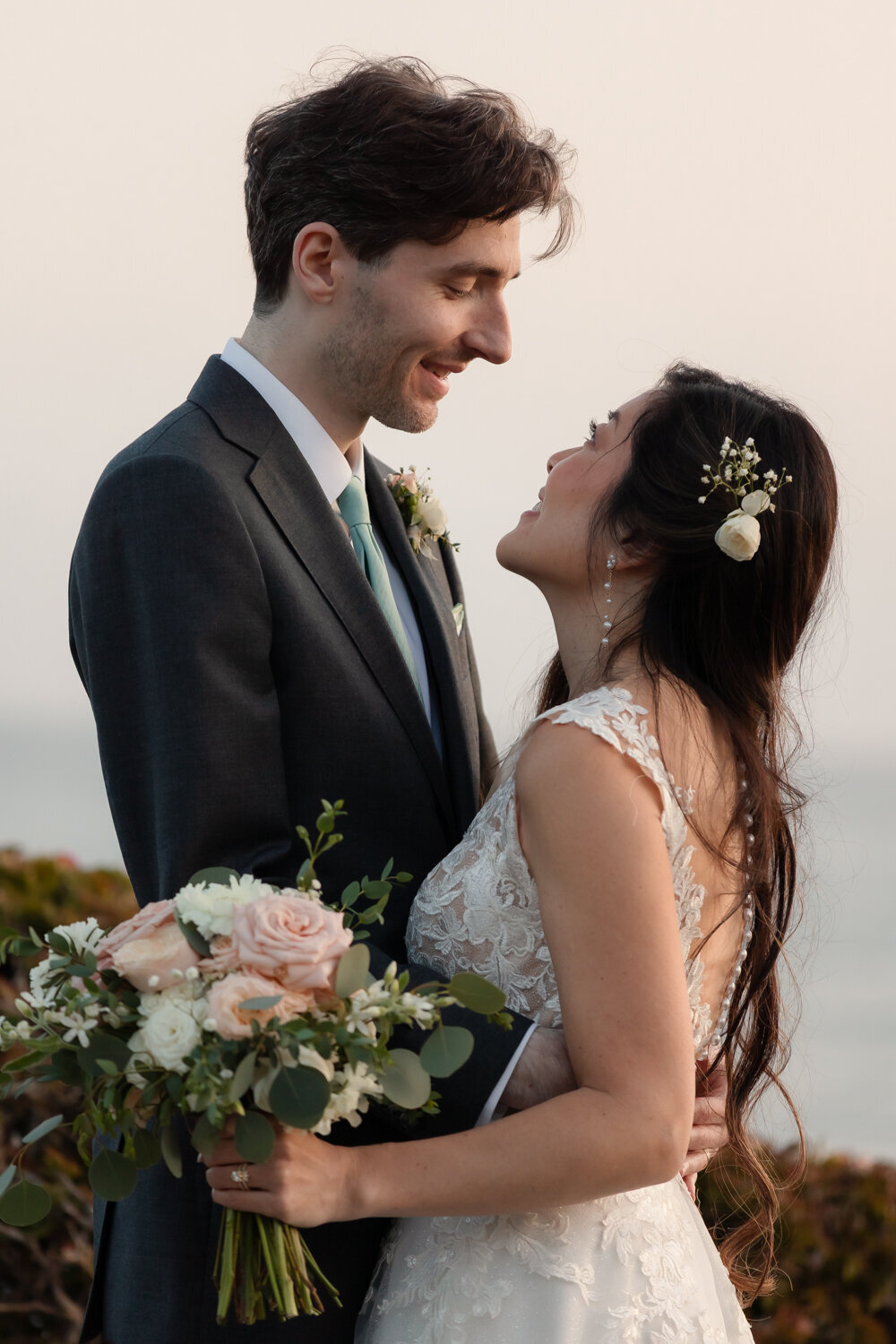 candid Wedding Photos of couple looking at each other in Pismo Beach at Dolphin Bay Resort & Spa
